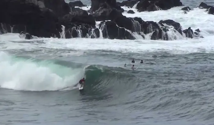 Surfing Maui near rocks